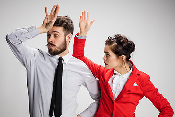 Image showing The business man and woman communicating on a gray background