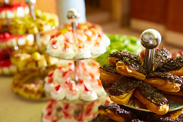 Image showing Dessert table for party. akes and sweetness. Shallow dof