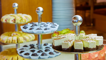 Image showing Dessert table for party. akes and sweetness. Shallow dof