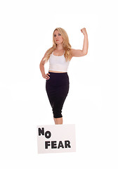 Image showing Woman standing with sign NO FEAR.