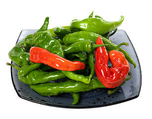 Image showing Green and red chili peppers on glass plate