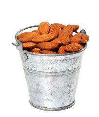 Image showing Old tin bucket with almonds