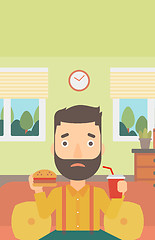 Image showing Man eating hamburger. 