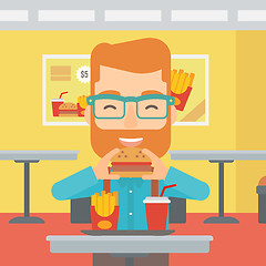 Image showing Man eating hamburger. 