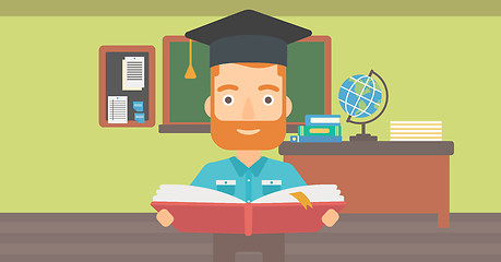 Image showing Man in graduation cap holding book.