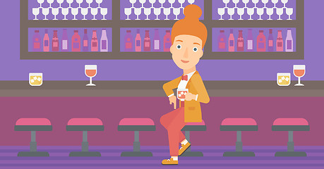 Image showing Woman sitting at bar.