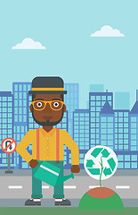 Image showing Man watering tree with recycle sign instead of crown.