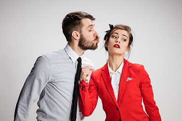 Image showing The business man and woman communicating on a gray background