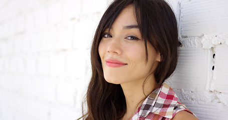 Image showing Serene woman with long brown hair stares at camera