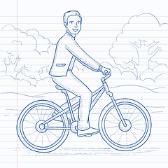Image showing Man riding bicycle.