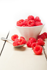 Image showing bunch of fresh raspberry on a bowl and white table