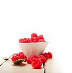 Image showing bunch of fresh raspberry on a bowl and white table