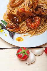 Image showing Italian seafood spaghetti pasta on red tomato sauce 