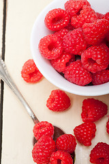 Image showing bunch of fresh raspberry on a bowl and white table