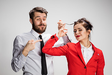 Image showing The business man and woman communicating on a gray background