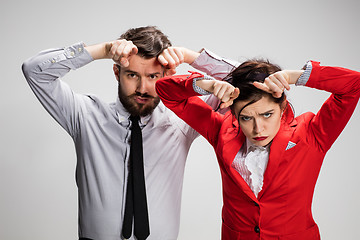 Image showing The business man and woman communicating on a gray background