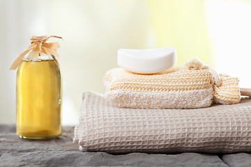 Image showing spa towels and aromatic massage oil