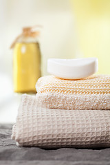 Image showing spa towels and aromatic massage oil