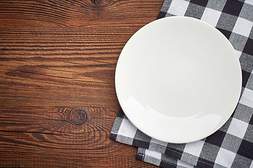 Image showing napkin and white plate on wooden table