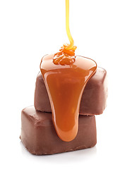 Image showing caramel sauce flowing on chocolate candies