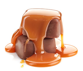 Image showing caramel sauce pouring on chocolate candies