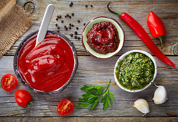 Image showing various sauces on wooden table