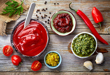 Image showing various sauces on wooden table