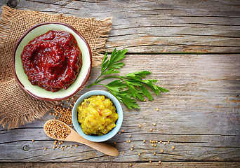 Image showing various sauces on wooden table