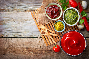 Image showing various sauces on wooden table