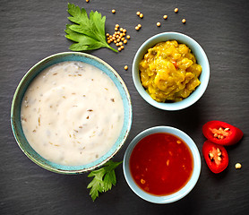 Image showing various sauces on black background