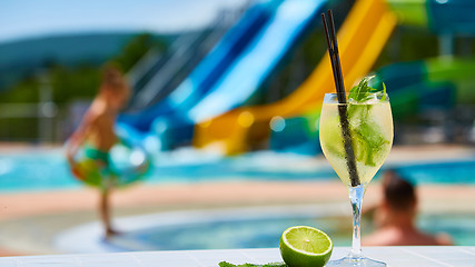 Image showing Close up Cocktail margaritas with lime near the swimming pool