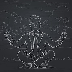 Image showing Businessman meditating in lotus pose.