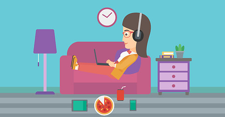 Image showing Woman lying on sofa with many gadgets.