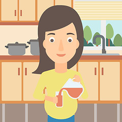 Image showing Pregnant woman pouring juice.