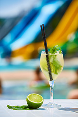 Image showing Close up Cocktail margaritas with lime near the swimming pool