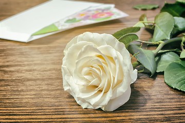 Image showing White rose and a letter of congratulation.