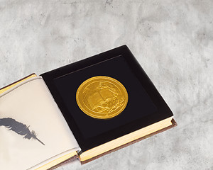 Image showing Medal with the image of the book and a Laurel branch