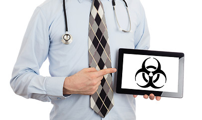 Image showing Doctor holding tablet - Warning! Biohazard!