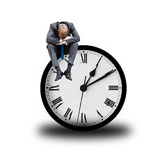 Image showing Tired businessman on clock