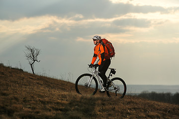 Image showing Man cyclist with backpack riding the bicycle