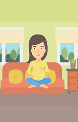 Image showing Pregnant woman sitting on sofa.