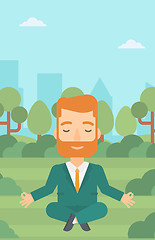 Image showing Businessman meditating in lotus pose.