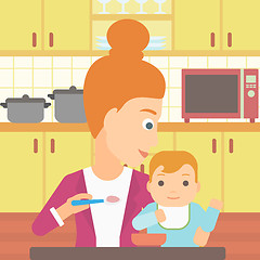 Image showing Woman feeding baby.