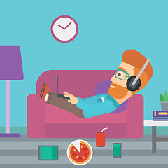 Image showing Man lying on sofa with many gadgets.