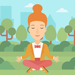 Image showing Business woman meditating in lotus pose.