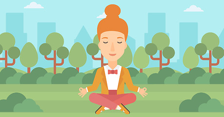 Image showing Business woman meditating in lotus pose.