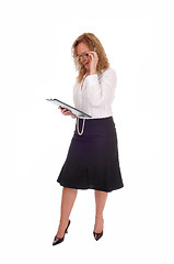 Image showing Business woman looking at her clipboard. 