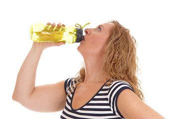 Image showing Workout woman drinking from her water bottle.