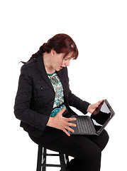 Image showing Woman wondering what is on laptop.