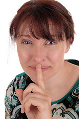 Image showing Lovely woman holding finger over mouth.